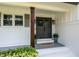 Inviting front porch with double doors, decorative plants, and stylish accents at 813 Faulkner Pl, Raleigh, NC 27609