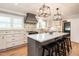 Beautiful kitchen featuring a large island with seating, elegant lighting, and updated appliances and fixtures at 813 Faulkner Pl, Raleigh, NC 27609