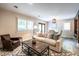 Open-concept living room with hardwood floors, neutral decor, and ample natural light at 813 Faulkner Pl, Raleigh, NC 27609