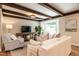 Comfortable living room with exposed beams, bay window, and stylish furnishings at 813 Faulkner Pl, Raleigh, NC 27609
