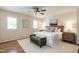 Serene main bedroom featuring hardwood floors, plantation shutters, a ceiling fan, and soothing color palette at 813 Faulkner Pl, Raleigh, NC 27609