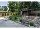 Backyard play area offers swing set, playhouse and stairs leading to the pool with chairs for watching the children at 813 Faulkner Pl, Raleigh, NC 27609