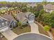 Aerial view of a landscaped home on a cul-de-sac, showcasing the front yard, driveway, and surrounding greenery at 829 Churton Pl, Cary, NC 27518
