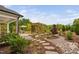 Landscaped backyard with stepping stones and a wood pergola covered with vines at 829 Churton Pl, Cary, NC 27518