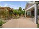 Beautiful backyard with covered patio, landscaping, and vine covered trellis at 829 Churton Pl, Cary, NC 27518