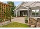 Backyard with stone outdoor kitchen, vine-covered trellis, and covered patio at 829 Churton Pl, Cary, NC 27518