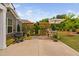 Inviting backyard with a stone patio, a built-in grill, trellises with vines and an outdoor dining area at 829 Churton Pl, Cary, NC 27518
