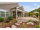 Backyard patio features a covered porch, landscaping, and stone walkway at 829 Churton Pl, Cary, NC 27518