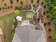 Birds eye view of a backyard with landscaped features, pergola, and an outdoor kitchen area with an umbrella at 829 Churton Pl, Cary, NC 27518