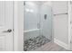 Modern bathroom with a glass-enclosed shower, tiled walls, and a built-in bench, designed for relaxation at 829 Churton Pl, Cary, NC 27518