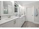 Bright bathroom featuring double sinks, white cabinetry, modern fixtures, and stylish tile flooring at 829 Churton Pl, Cary, NC 27518