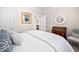 Cozy bedroom with white bedding, wood dresser and art, and ensuite access at 829 Churton Pl, Cary, NC 27518