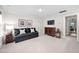 Bonus room featuring neutral carpet, black sofa, and dark wood furniture at 829 Churton Pl, Cary, NC 27518