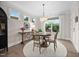 Charming dining area featuring a round table, elegant chandelier, and lovely views of the landscaped backyard at 829 Churton Pl, Cary, NC 27518