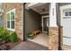 Charming front porch with stone accents, wooden bench, and stylish door at 829 Churton Pl, Cary, NC 27518