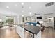 Open-concept kitchen featuring a large island with stainless steel appliances, and views of the dining area and living room at 829 Churton Pl, Cary, NC 27518