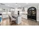 Modern kitchen with a kitchen island, stainless steel appliances, a stylish range hood, and ample cabinet space at 829 Churton Pl, Cary, NC 27518