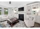 Cozy living room with a fireplace, built-in bookshelves, comfortable seating, and a stylish area rug at 829 Churton Pl, Cary, NC 27518