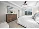 Comfortable main bedroom featuring a tray ceiling, large window with blinds, and neutral decor, a peaceful retreat at 829 Churton Pl, Cary, NC 27518