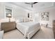 Serene main bedroom with a tray ceiling, soft lighting, and a glimpse into the ensuite bathroom at 829 Churton Pl, Cary, NC 27518