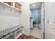 Functional mud room with a built-in bench, storage hooks, and a view into the laundry area, perfect for organization at 829 Churton Pl, Cary, NC 27518