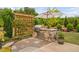Outdoor kitchen area with stainless steel grill and stone surround at 829 Churton Pl, Cary, NC 27518