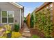 Landscaped side yard with stepping stones and vine covered trellis at 829 Churton Pl, Cary, NC 27518
