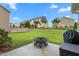 Manicured backyard with fire pit and views of surrounding homes at 839 Old Towne Dr, Elon, NC 27244