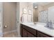 Bathroom featuring dark wood cabinets, light countertops, and a large mirror above the sink at 839 Old Towne Dr, Elon, NC 27244