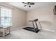 Bedroom with a treadmill, carpeted floor, and window, creating a fitness-friendly space at 839 Old Towne Dr, Elon, NC 27244