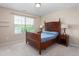 Cozy bedroom with neutral carpet, wooden furniture, and natural light streaming in through the window at 839 Old Towne Dr, Elon, NC 27244