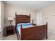 Well-lit bedroom features a wooden bed frame, side tables, and neutral walls at 839 Old Towne Dr, Elon, NC 27244