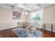 Elegant dining room featuring a coffered ceiling, chandelier, table with four chairs, and a large window at 839 Old Towne Dr, Elon, NC 27244