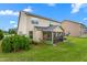Exterior of home with screened porch and lush landscaping in the backyard at 839 Old Towne Dr, Elon, NC 27244
