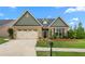 Inviting single-Gathering home with brick, siding, a two-car garage, manicured lawn, and a charming front entrance at 839 Old Towne Dr, Elon, NC 27244