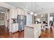 This kitchen has stainless appliances, granite counters, white cabinets, hardwood floors, and an island at 839 Old Towne Dr, Elon, NC 27244