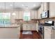 Bright kitchen with granite countertops, stainless appliances, decorative backsplash, and white cabinets at 839 Old Towne Dr, Elon, NC 27244