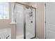 Shower with glass doors and window, offering a bright and modern bathroom space at 839 Old Towne Dr, Elon, NC 27244