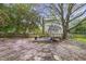 Charming backyard features mature trees, a playhouse, and stepping stone pathway at 8608 Cheerful Ct, Raleigh, NC 27615
