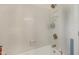 Clean bathtub with white tiled walls, updated fixtures, and a built-in shower caddy at 8608 Cheerful Ct, Raleigh, NC 27615