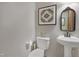 Stylish half bathroom with pedestal sink, patterned decor, and soft lighting is perfect for guests at 8608 Cheerful Ct, Raleigh, NC 27615