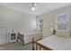 Well-lit bedroom with two twin beds, a white dresser, and soft carpet throughout at 8608 Cheerful Ct, Raleigh, NC 27615