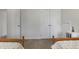Bedroom featuring two twin beds and built-in closets, offering ample storage space at 8608 Cheerful Ct, Raleigh, NC 27615