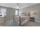 Comfortable bedroom with neutral colors, ceiling fan, and ample natural light offers a relaxing space at 8608 Cheerful Ct, Raleigh, NC 27615