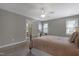 Spacious bedroom features neutral walls, ceiling fan, and a doorway leading to the ensuite bathroom at 8608 Cheerful Ct, Raleigh, NC 27615