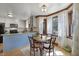 Bright dining area features a bay window, wood trim, stylish light fixture and access to kitchen at 8608 Cheerful Ct, Raleigh, NC 27615