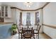 Light-filled dining area with bay window, wood trim, and chandelier is great for Gathering meals at 8608 Cheerful Ct, Raleigh, NC 27615