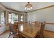 Spacious dining room featuring large table with hardwood floors and natural light for an inviting space at 8608 Cheerful Ct, Raleigh, NC 27615