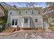 Rear exterior view of the home featuring a patio, bay window, and manicured lawn at 8608 Cheerful Ct, Raleigh, NC 27615