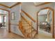 Foyer with hardwood floors, wooden trim, carpeted stairs leading to the second floor, and doorways to other rooms at 8608 Cheerful Ct, Raleigh, NC 27615